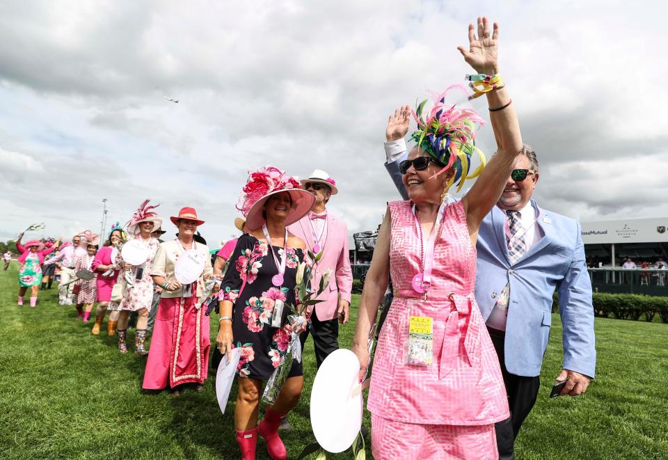 Cyndi McHolland of Jeffersonville waved to the crowd during the Survivors Parade Friday on Oaks day. May 3, 2019