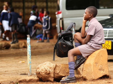 Zimbabwean schoolchild awaits transport from school during a teachers' strike in Harare, Zimbabwe, February 8, 2019. REUTERS/Philimon Bulawayo