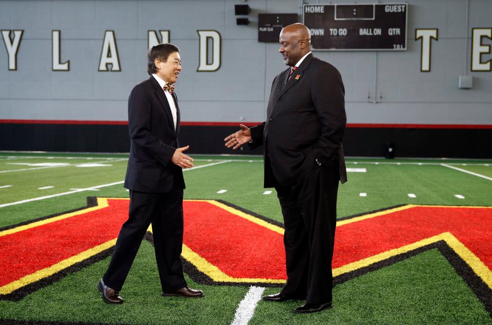 University of Maryland president Wallace Loh, left, shakes hands with new Maryland head football coach Mike Locksley after an NCAA college football news conference, Thursday, Dec. 6, 2018, in College Park, Md. Locksley, Alabama's offensive coordinator, will take over at Maryland after the most tumultuous year in the program's recent history. (AP Photo/Patrick Semansky)