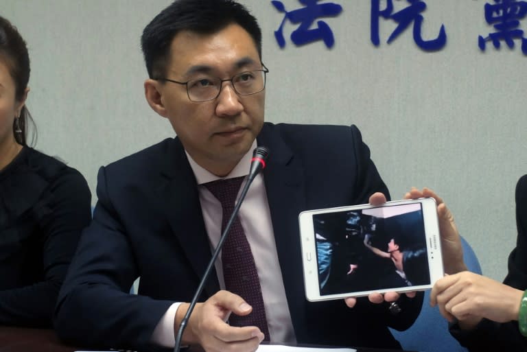 Johnny Chiang, a legislator from the Kuomintang (KMT) party, displays a video showing Taiwanese detented at a police station in Kenya, during a press conference in Taipei, in April 2016