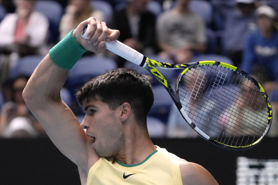 Carlos Alcaraz of Spain plays a forehand return to Lorenzo Sonego of Italy during their second round match at the Australian Open tennis championships at Melbourne Park, Melbourne, Australia, Thursday, Jan. 18, 2024. (AP Photo/Andy Wong)