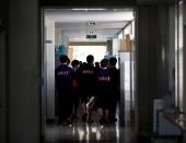 Students of Fukushima Commercial High School walk inside the school in Fukushima, Japan