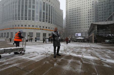 A man takes a selfie during snowfall in Canary Wharf in London, Britain February 27, 2018 REUTERS/Kevin Coombs