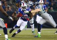 TORONTO, ON - DECEMBER 16: C.J. Spiller #28 of the Buffalo Bills rushes during an NFL game as Heath Farwell #55 of the Seattle Seahawks tackles him at Rogers Centre on December 16, 2012 in Toronto, Ontario, Canada. (Photo by Tom Szczerbowski/Getty Images)