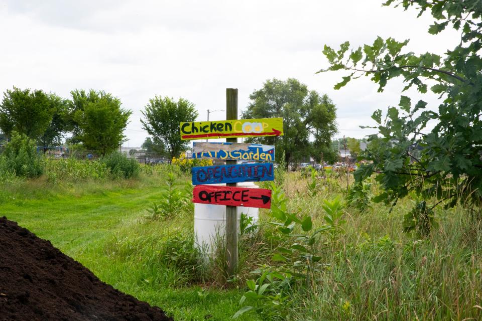 A sign points to different sections of Unity Gardens in South Bend on Monday, Aug. 7, 2023.