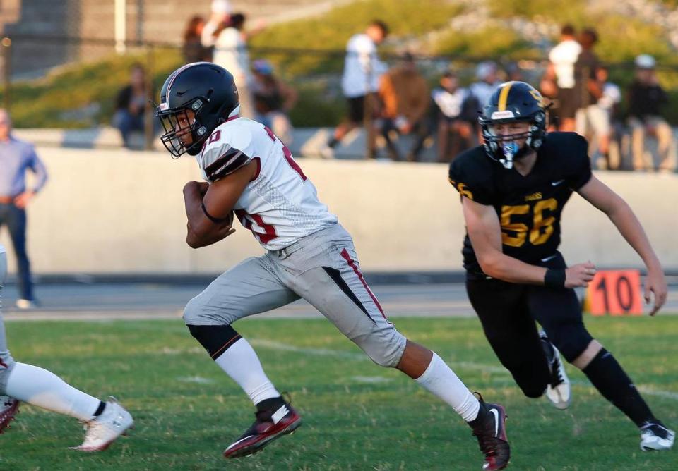 Titan Malachi Starr (20) is chased by SLO defensive tackle Mauricio Martinon (55). San Luis Obispo beat Nipomo 38-7 in a nonleague game at San Luis Obispo High School’s Holt Field stadium, Aug. 18, 2023.