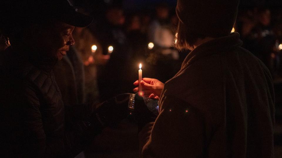 Service members hold candles in honor of those impacted by suicide, domestic violence, sexual assault and harassment at Spangdahlem Air Base, Germany, Sept. 30, 2022. (Airman 1st Class Imani West/Air Force)