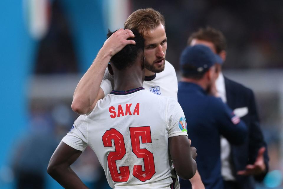 England captain Harry Kane consoles teenage midfielder Bukayo Saka after their loss in the UEFA Euro 2020 final football match to Italy at the Wembley Stadium in London on Sunday. Photo: Laurence Griffiths/Pool/ AFP via Getty