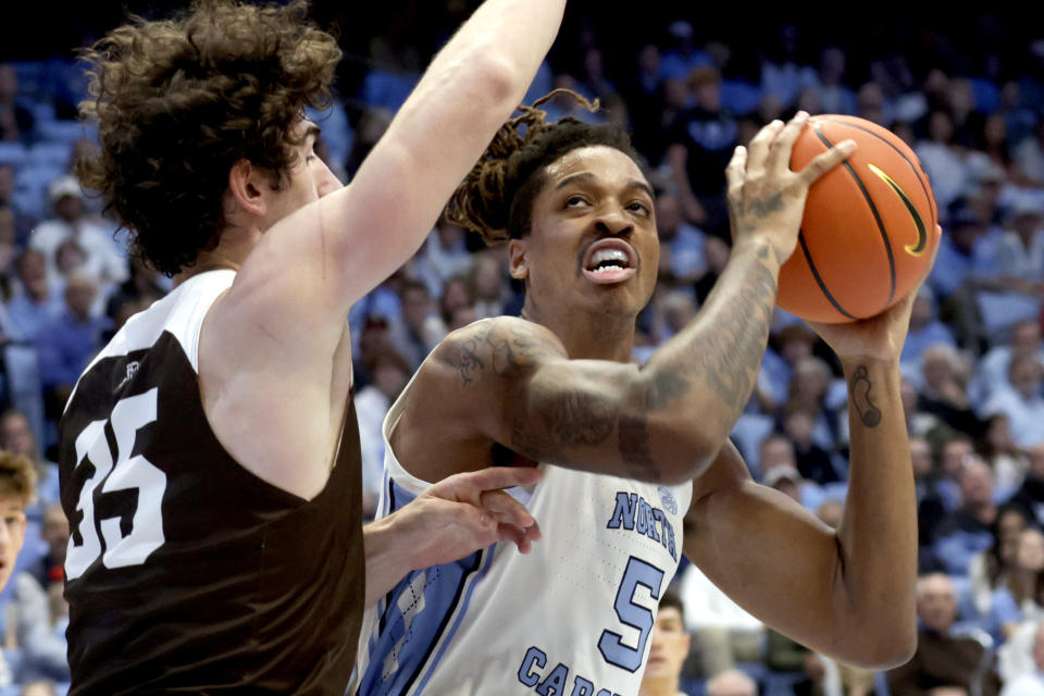 North Carolina forward Armando Bacot (5) works against Lehigh forward Dominic Parolin (35) during the first half of an NCAA college basketball game Sunday, Nov. 12, 2023, in Chapel Hill, N.C. (AP Photo/Chris Seward)