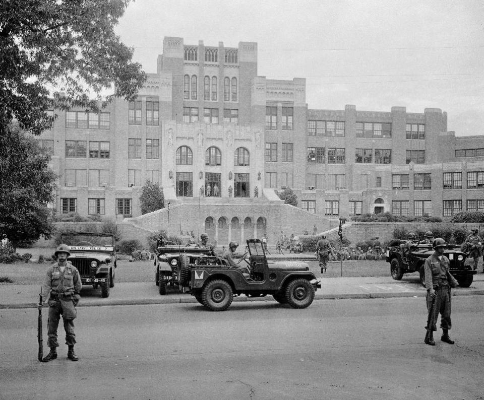 FILE - In this Sept. 26, 1957 file photo, members of the 101st Airborne Division take up positions outside Central High School in Little Rock, Ark. The troopers are on duty to enforce integration at the school. Five decades and $1 billion after an infamous racial episode made Little Rock a symbol of school segregation, the legal fight to ensure all of its children receive equal access to education has ended. (AP Photo, File)