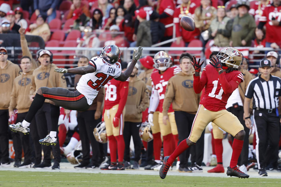 San Francisco 49ers wide receiver Brandon Aiyuk (11) catches a touchdown pass against Tampa Bay Buccaneers cornerback Jamel Dean (35) during the second half of an NFL football game in Santa Clara, Calif., Sunday, Nov. 19, 2023. (AP Photo/Josie Lepe)