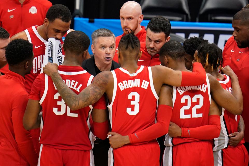 Ohio State head coach Chris Holtmann, fourth from left, talks with his team during the second half of a college basketball game against Villanova in the second round of the NCAA tournament in Pittsburgh, Sunday, March 20, 2022. Villanova won 71-61. (AP Photo/Gene J. Puskar)