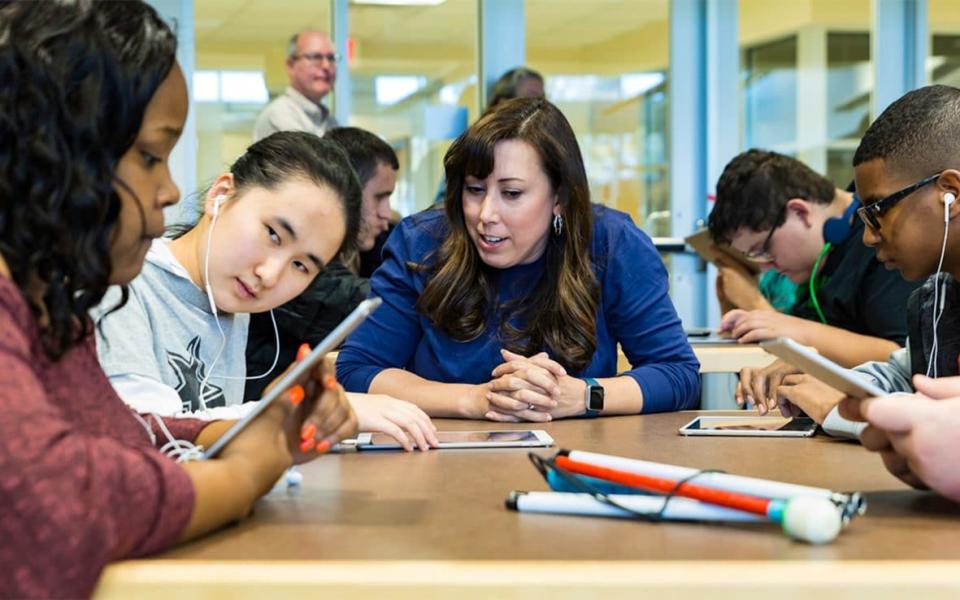 Apple's Everyone Can Code programme will expand in the UK - here students are seen using its software at a blind school in Texas - Apple