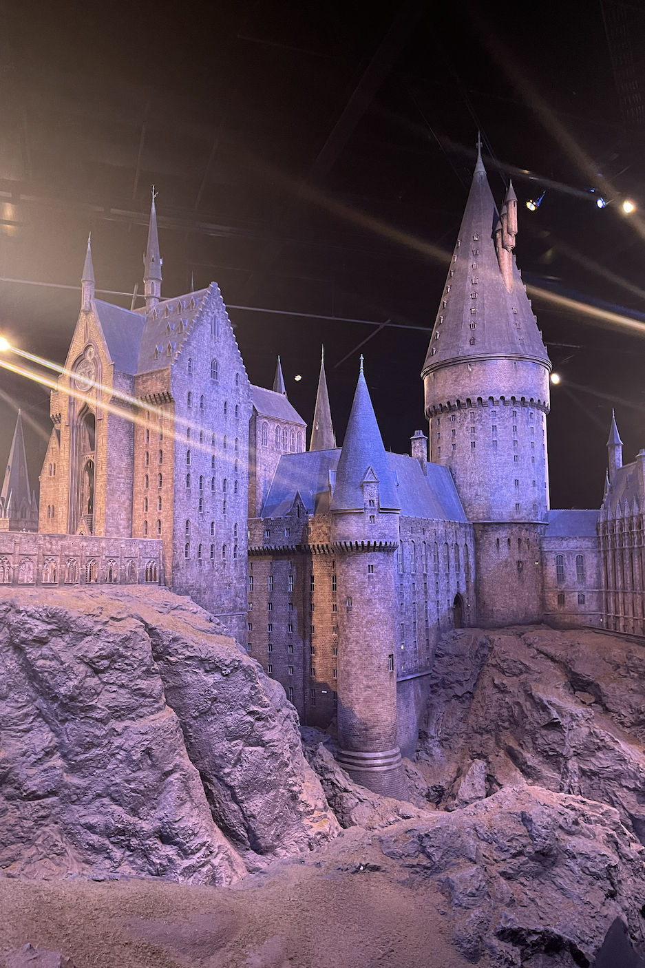 Scale model of Hogwarts Castle from the Harry Potter series displayed in dim lighting