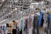 A woman works in the automated sortation section at Rent the Runway's "Dream Fulfillment Center" in Secaucus, New Jersey