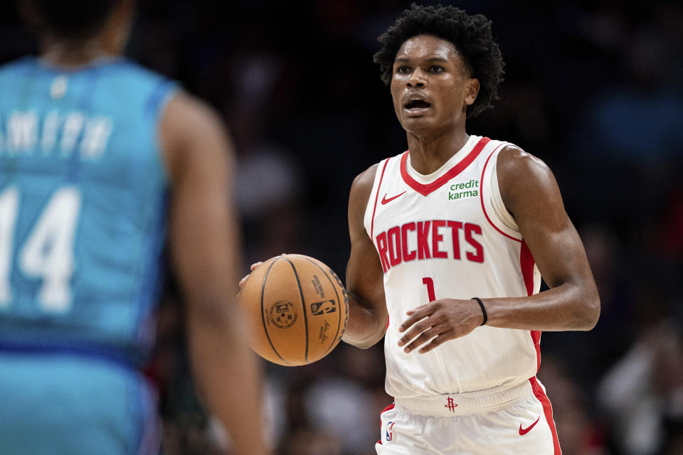 Houston Rockets forward Amen Thompson brings the ball up during the first half of the team's NBA basketball game against the Charlotte Hornets on Friday, Jan. 26, 2024 in Charlotte, N.C. (AP Photo/Jacob Kupferman)