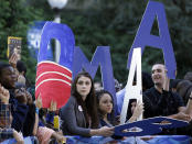 Students show their support for President Barack Obama as they gather around a television network set on the campus of Hofstra University in Hempstead, N.Y., Tuesday, Oct. 16, 2012, site of the Presidential debate. President Obama and Republican presidential candidate, former Massachusetts Gov. Mitt Romney will hold their second debate Tuesday. (AP Photo/Eric Gay)