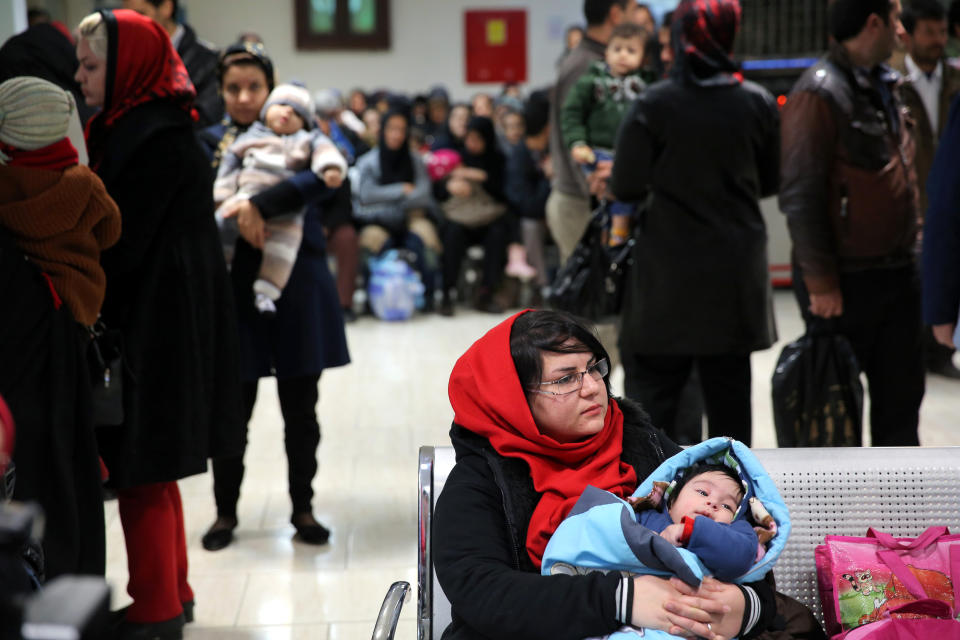 In this Monday, Dec. 30, 2013 photo, an Iranian woman holds her child at the Mofid Children's Hospital in Tehran, Iran. Having curbed birth rates for two decades, Iran is once again promoting a baby boom to help make up for its graying population. But experts say it is difficult to encourage Iranians to have more children under a sanctions-hit economy and 36 percent inflation. (AP Photo/Ebrahim Noroozi)