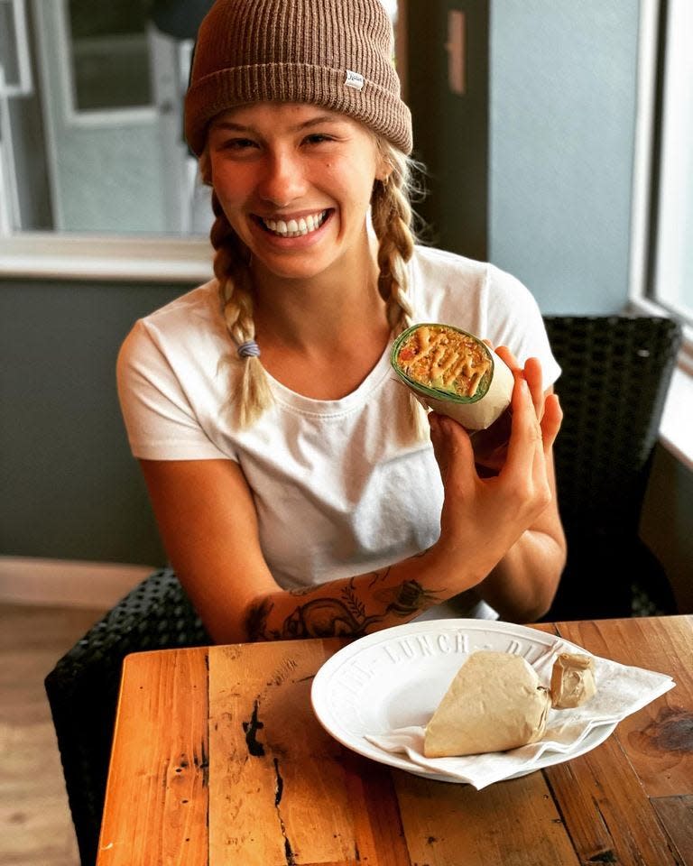 A customer enjoys a wrap at Café del Soul, a newly opened New Smyrna Beach eatery.