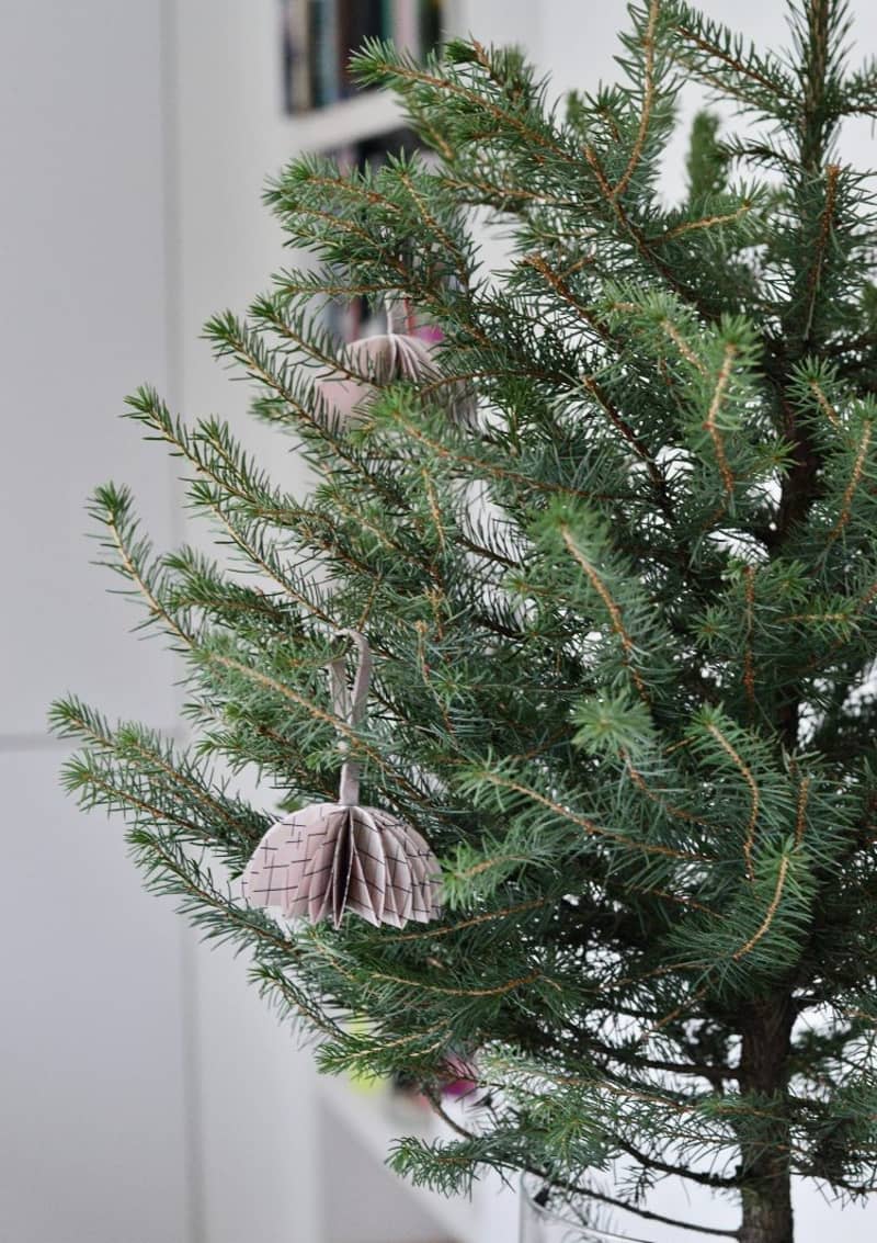 Half-bauble origami puffs hung from the branches of a Christmas tree