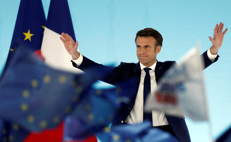 Emmanuel Macron reacts on stage after partial results were announced on Sunday evening (REUTERS)