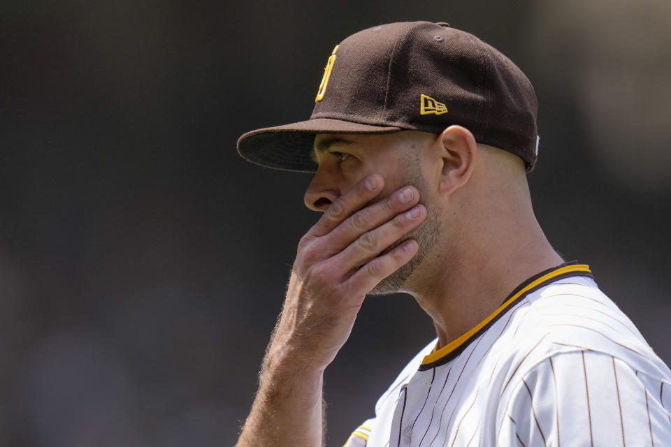 San Diego Padres starting pitcher Nick Martinez wipes his face during the first inning of a baseball game against the Atlanta Braves, Wednesday, April 19, 2023, in San Diego. (AP Photo/Gregory Bull)