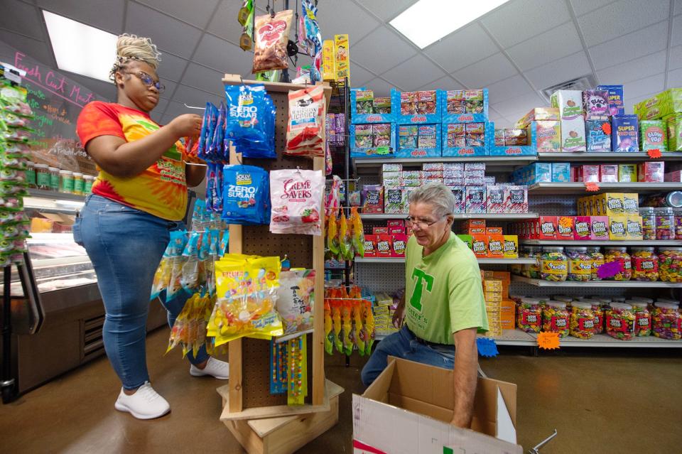 Generations merge into one team at Trotter’s Market in Jackson, as teen Nia Vaughan, 18, left, and Robbie Battistelli, 61, right, both of Jackson, work on restocking items. Vaughan has worked at the market for a year and Battistelli has been there a few months longer. “I love it,” Battistelli said. “I was in the car business for 30 years and I just got tired of it.”
