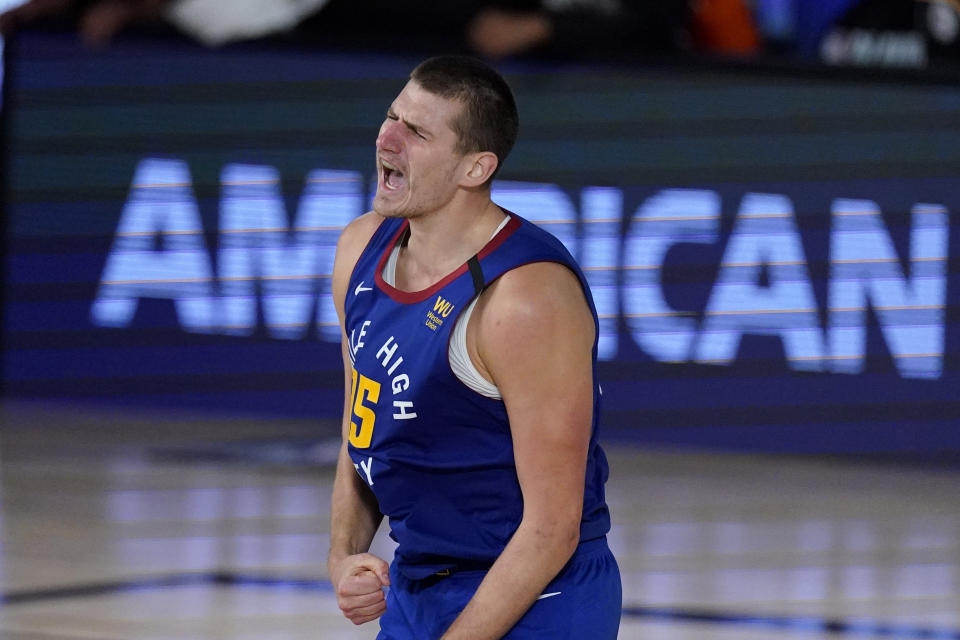 Denver Nuggets' Nikola Jokic (15) celebrates after a basket during the second half of an NBA conference semifinal playoff basketball game against the Los Angeles Clippers, Friday, Sept. 11, 2020, in Lake Buena Vista, Fla. (AP Photo/Mark J. Terrill)