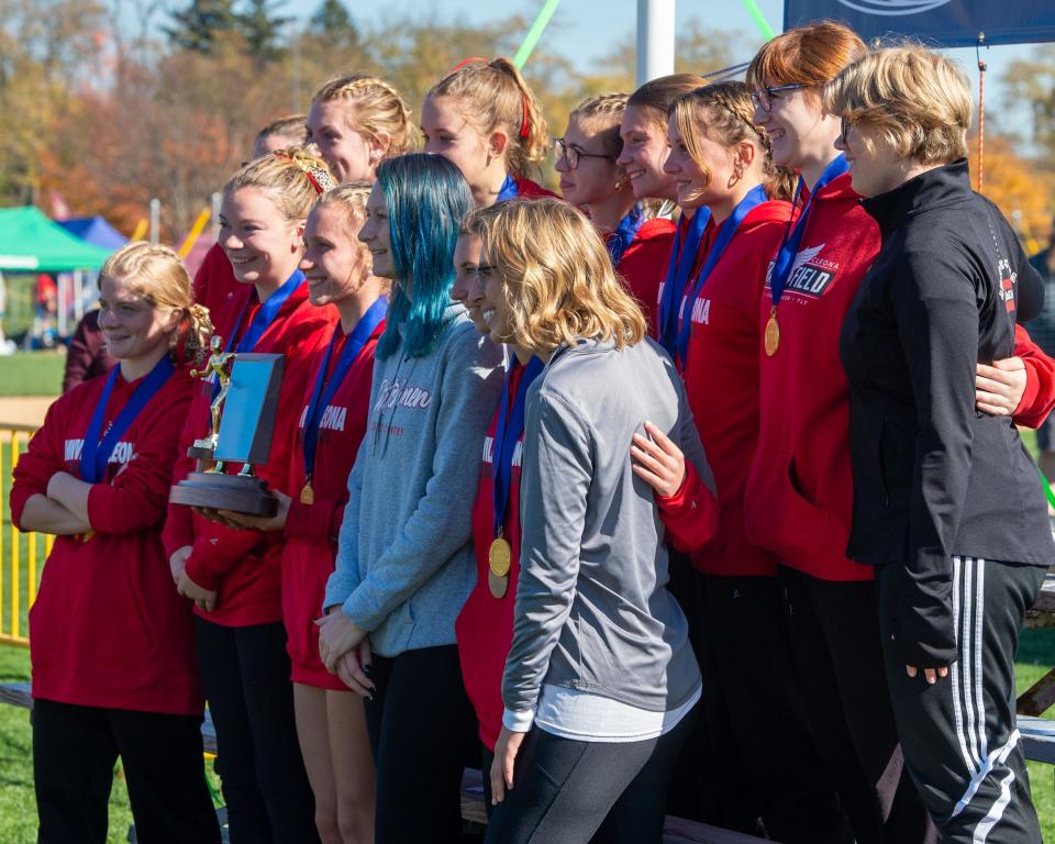 Members of the Annville-Cleona cross country team pose with their trophy after winning the District 3 Class 2A girls’ team title at Big Spring High School on Saturday, Oct. 29, 2022.