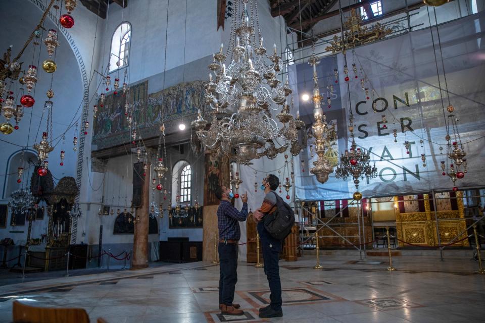 Tourists visit the Church of the Nativity, in the West Bank city of Bethlehem on Nov. 16. The Church of the Nativity, built on the spot where Christians believe Jesus was born, is wrapping up a three-year restoration project just in time for the normally busy Christmas season.
