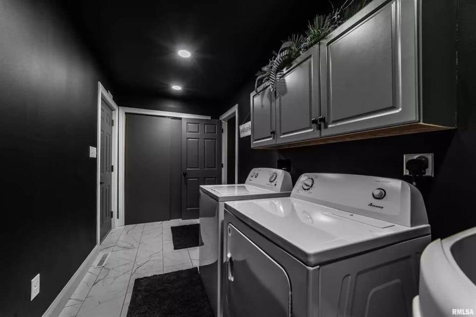 Even the utility room in the all-black "goth" house follows the property's strict color scheme.