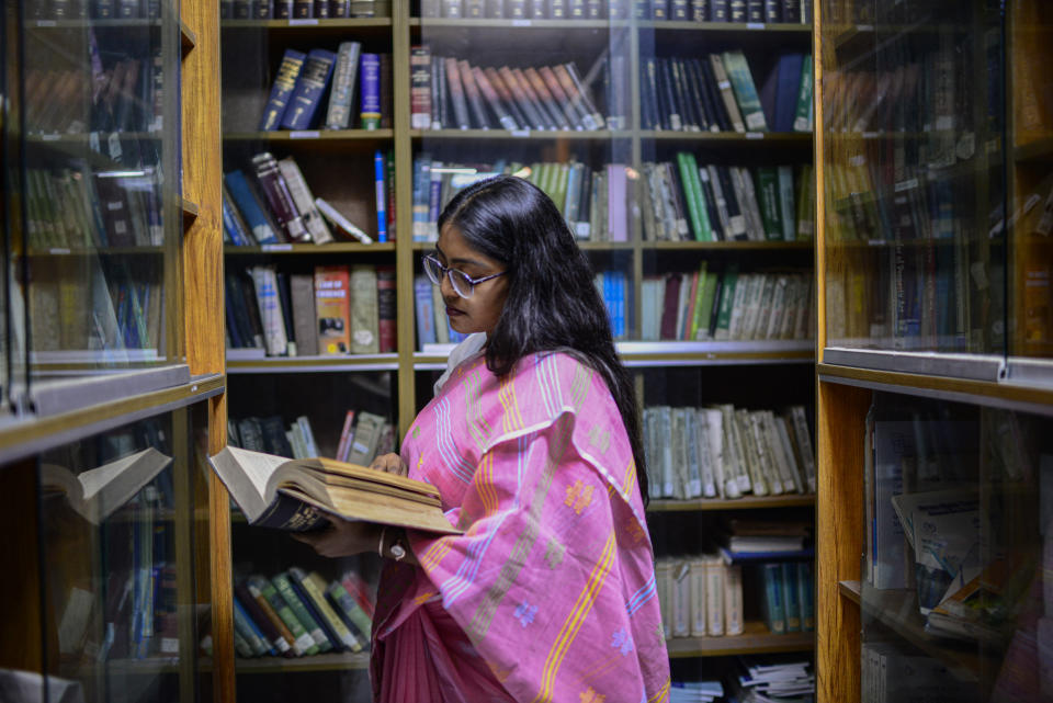 Shahrima Tanjin Arni, 26, who teaches law at Dhaka University, reads a book in Dhaka, Bangladesh, Dec. 12, 2023. “I feel that Sheikh Hasina is that leader in Bangladesh who is a perfect combination of both generations,” Arni said. “She holds the values of the past, but at the same time, she has a progressive thinking in her progressive heart, which is not very common in Bangladeshi societies.” Arni credits Hasina for being a “ bold leader” with a vision for a digital future. (AP Photo/Mahmud Hossain Opu)