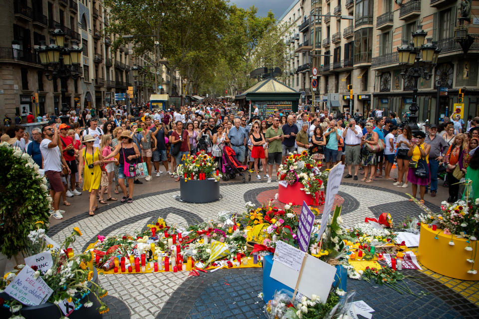 BARCELONA, SPAIN - AUGUST 17:  A woman places a flowers in a floral tribute at Las Ramblas on August 17, 2018 in Barcelona, Spain. The Barcelona City Council organized a ceremony in memory of the victims of the Barcelona and Cambrils attacks where 16 people where killed and more than 150 injured.  (Photo by David Ramos/Getty Images)