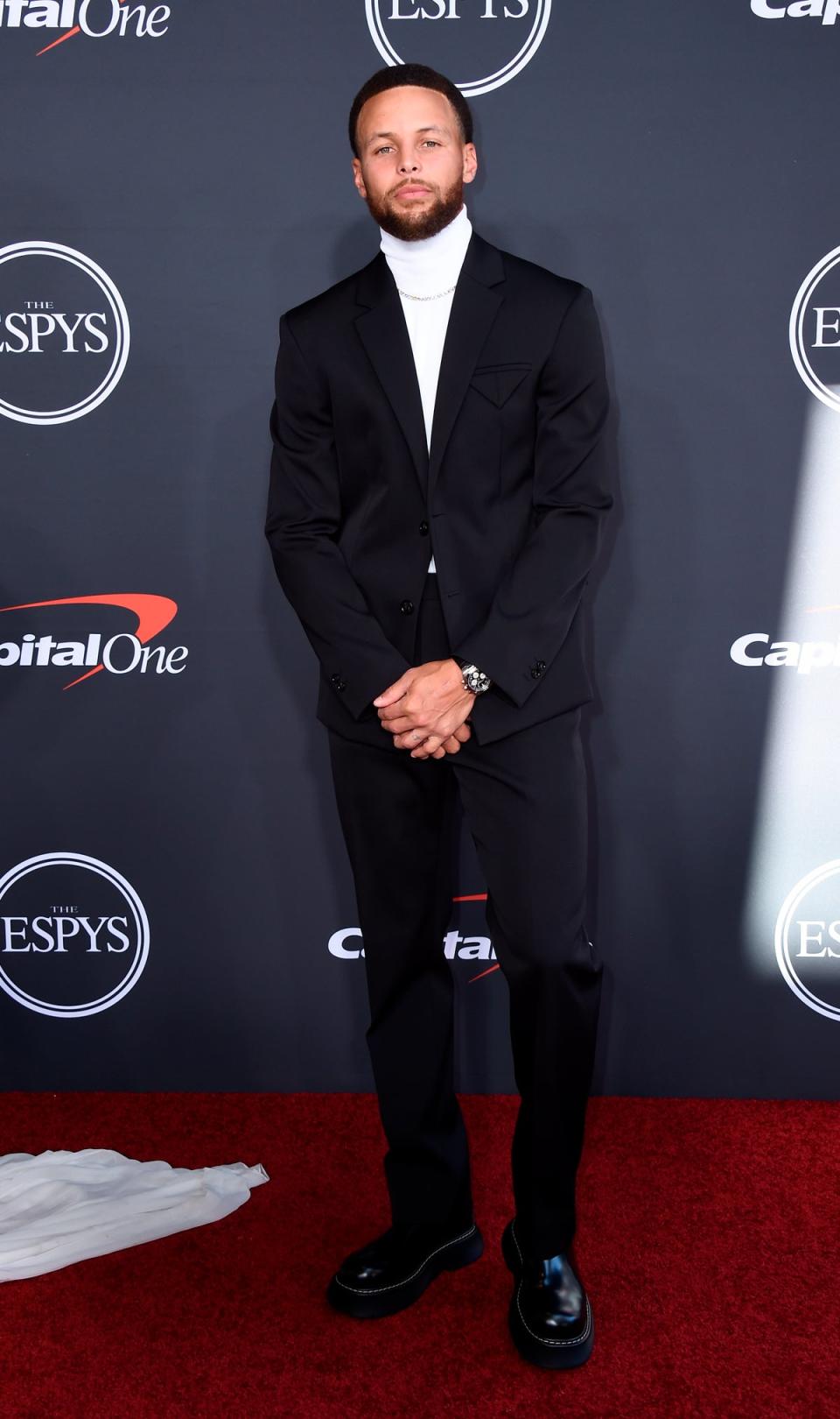 NBA champion Curry wore a simple white roll neck sweatshirt underneath a black suit by Bottega Veneta (Jordan Strauss/AP) (AP)