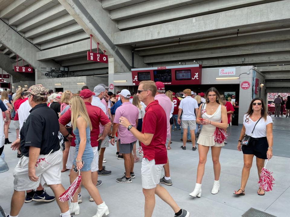 Fans walk around near the concession stand on the west upper deck before the University of Alabama's Oct. 2, 2021, football game against Ole Miss at Bryant-Denny Stadium. [Staff photo/Ken Roberts]