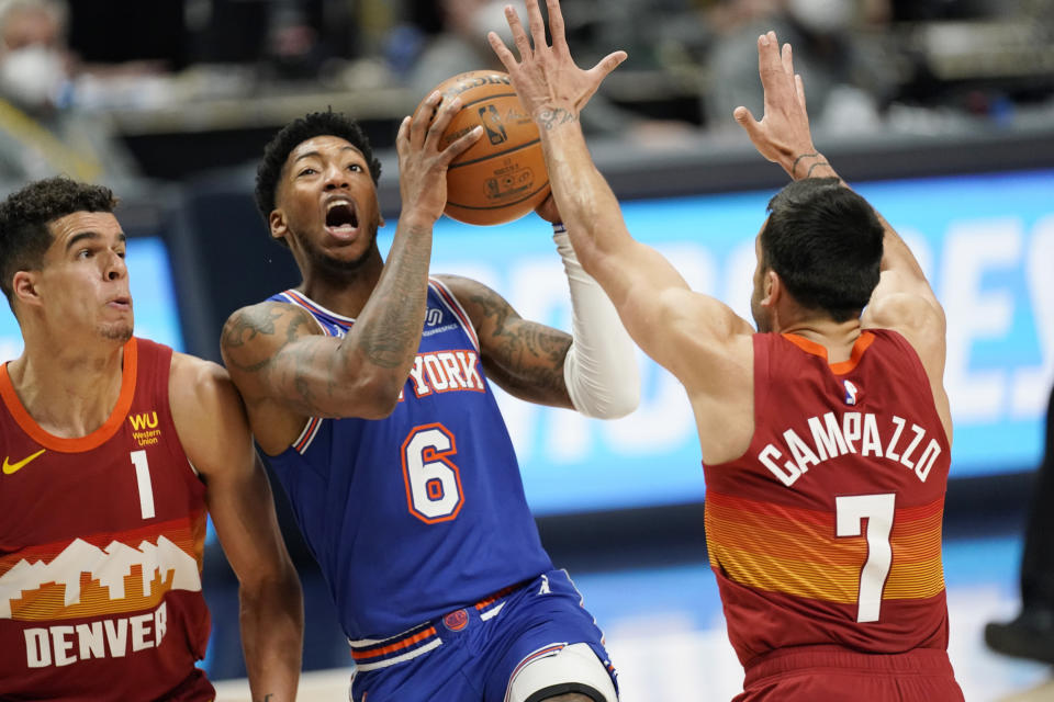 New York Knicks guard Elfrid Payton (6) drives to the rim between Denver Nuggets forward Michael Porter Jr. (1) and guard Facundo Campazzo (7) in the second half of an NBA basketball game Wednesday, May 5, 2021, in Denver. (AP Photo/David Zalubowski)