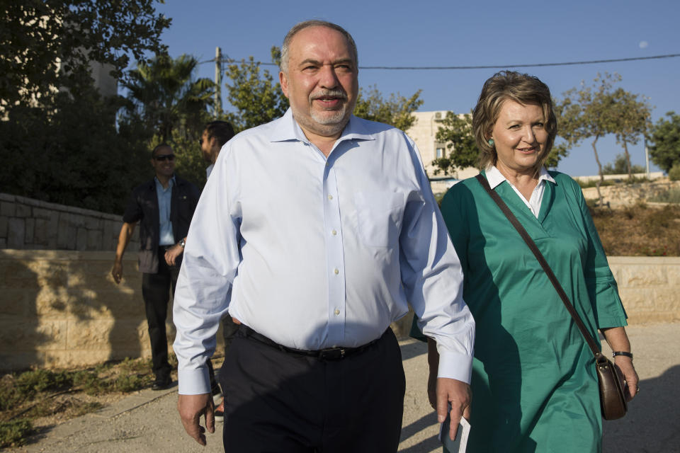 FILE - In this Tuesday, Sept. 17, 2019 file photo, leader of the Yisrael Beiteinu right-wing nationalist party Avigdor Liberman arrives to vote with is wife Ella in the settlement of Nokdim, West Bank. In Israel's secular heartland, the role of religion in daily life played a central role in this week's deadlocked election. Lieberman positioned himself as the primary power broker by making it his signature cause and defecting from Netanyahu's camp over what he called its capitulation to the ultra-Orthodox. (AP Photo/Tsafrir Abayov, File)