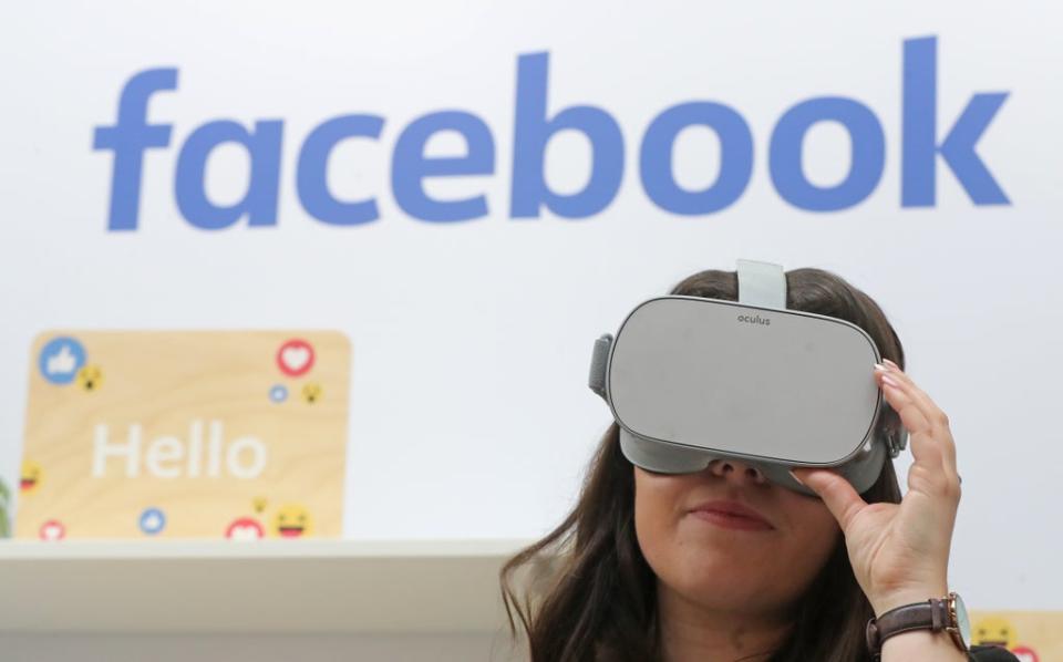 A woman uses an Oculus virtual reality headset at the Facebook stand during the Dublin Tech Summit (Niall Carson/PA) (PA Archive)