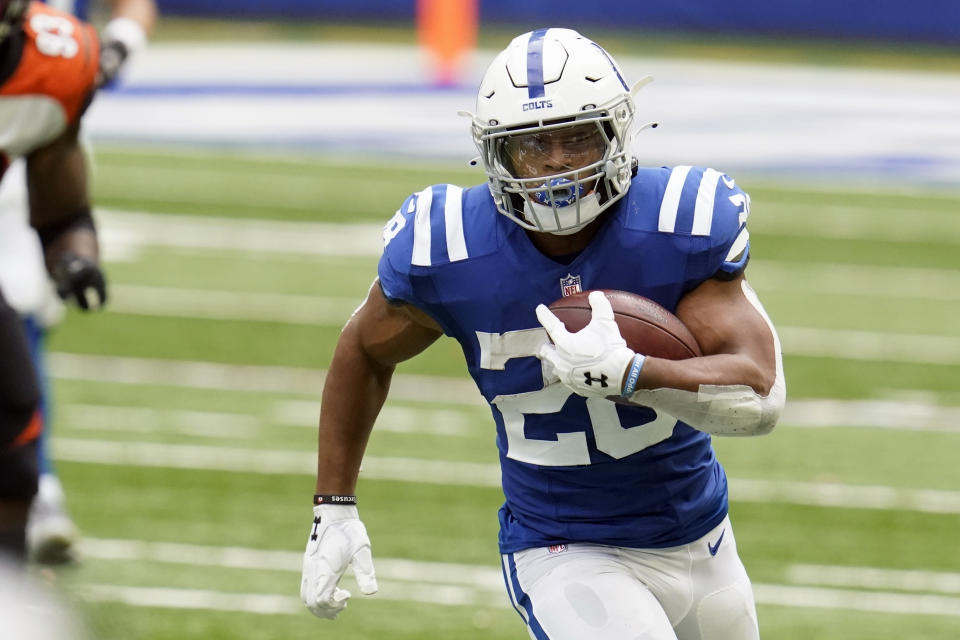 FILE- In this Sunday, Oct. 18, 2020, file photo, Indianapolis Colts' Jonathan Taylor (28) carries the ball during the second half of an NFL football game against the Cincinnati Bengals in Indianapolis. The Detroit Lions are hosting the Indianapolis Colts hoping to win three straight games for the first time in three seasons under coach Matt Patricia. The Colts are aiming to improve to 3-0 coming off bye weeks with coach Frank Reich. (AP Photo/Michael Conroy, File)