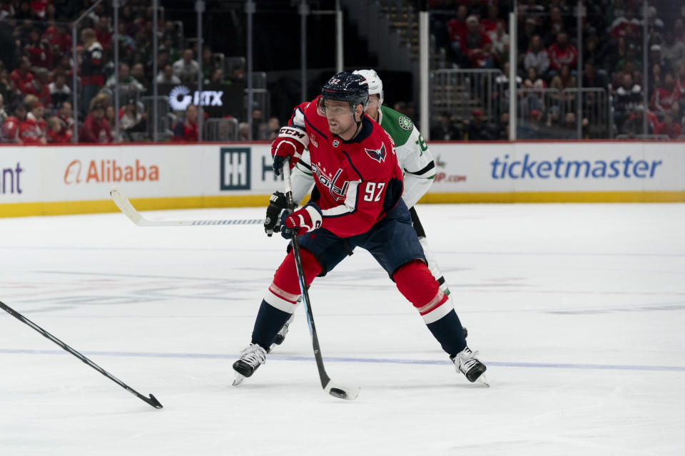 Washington Capitals center Evgeny Kuznetsov (92) shoots in front of Dallas Stars center Sam Steel (18) during the first period of an NHL hockey game, Thursday, Dec. 7, 2023, in Washington. (AP Photo/Stephanie Scarbrough)