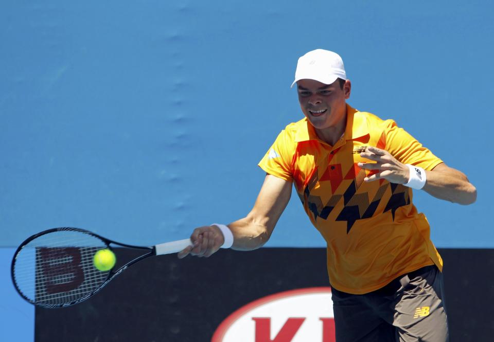 Milos Raonic of Canada hits a return to Daniel Gimeno-Traver of Spain during their men's singles match at the Australian Open 2014 tennis tournament in Melbourne January 14, 2014. REUTERS/Brandon Malone (AUSTRALIA - Tags: SPORT TENNIS)