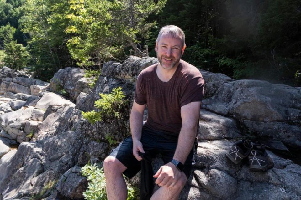 Bruce Lake is seen catching his breath after rescuing the woman from the rushing river waters in Fundy National Park Saturday. 