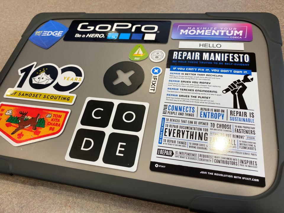 The stickers on Logan Fike's laptop reflect his busy life and varied interests.