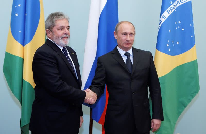 FILE PHOTO: Brazil's President Luiz Ignacio Lula da Silva shakes hands with Russia's Prime Minister Putin as they meet in Moscow