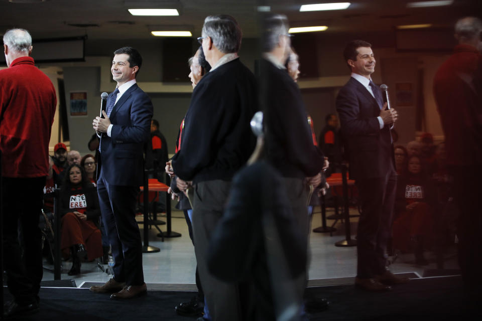 Reflected on the surface of a TV screen, democratic presidential candidate South Bend Mayor Pete Buttigieg speaks at a culinary workers union hall Saturday, Jan. 11, 2020, in Las Vegas. (AP Photo/John Locher)