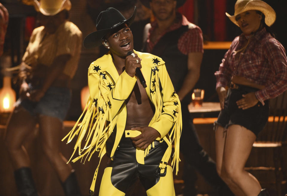 FILE - This June 23, 2019 file photo shows Lil Nas X performing his X’s genre bending "Old Town Road" at the BET Awards in Los Angeles. The rapper won many awards, including Grammys for best music video and best pop duo/group performance, an American Music Award for favorite rap/hip-hop and a CMA award for musical event of the year. (Photo by Chris Pizzello/Invision/AP, File)