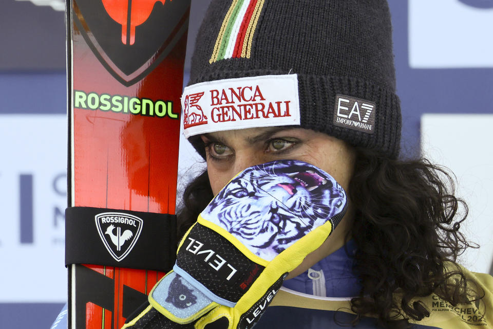 Italy's Federica Brignone, winner of an alpine ski, women's World Championship combined race, is overcome by emotion on the podium during the national anthem, in Meribel, France, Monday, Feb. 6, 2023. (AP Photo/Marco Trovati)