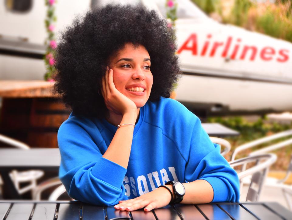 Cuban R&B-pop singer Chila Lynn sits at an outdoor table at El Ambia Cubano in downtown Melbourne the afternoon before her American singing debut.