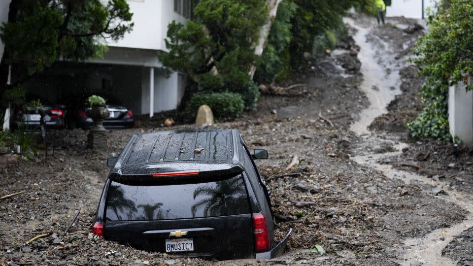 An SUV sits buried by a mudslide on Feb. 5, 2024, in the Beverly Crest area of Los Angeles. El Niño has a strong linkage to a wetter winter in California like what happened this year. - Marcio Jose Sanchez/AP