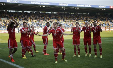 Bayern Munich players celebrate after their German first division Bundesliga soccer match against Eintracht Braunschweig in Berlin, April 19, 2014. REUTERS/Fabrizio Bensch